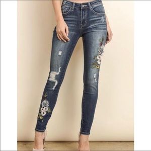 Distressed embroidered denim jeans.